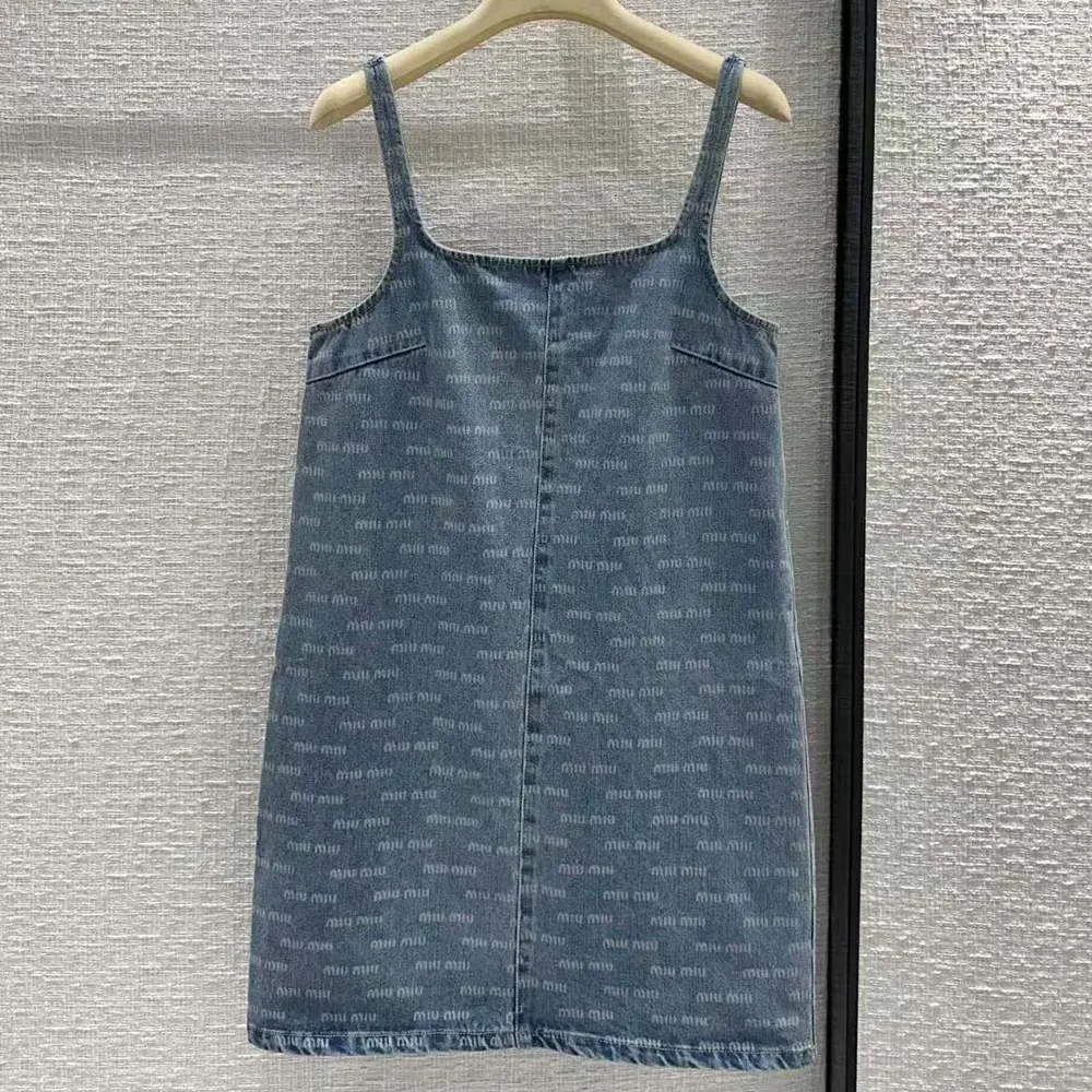 Close-up on signature buttons and blue denim fabric of Miu Miu Women Denim Dress