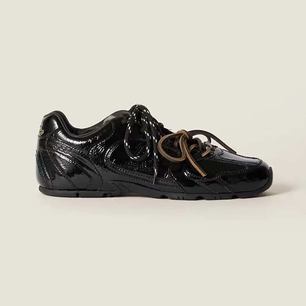 Side view of Miu Miu Women New Balance X Miu Miu 530 SL Patent Leather Sneakers in black