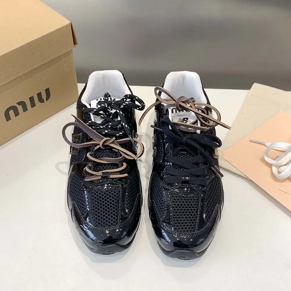 Close-up on glossy patent leather and laces of Miu Miu Women New Balance X Miu Miu 530 SL Sneakers