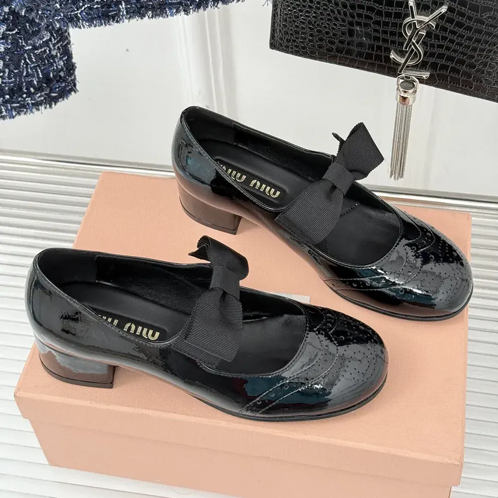 Close-up of glossy patent leather and signature bow on Miu Miu pumps
