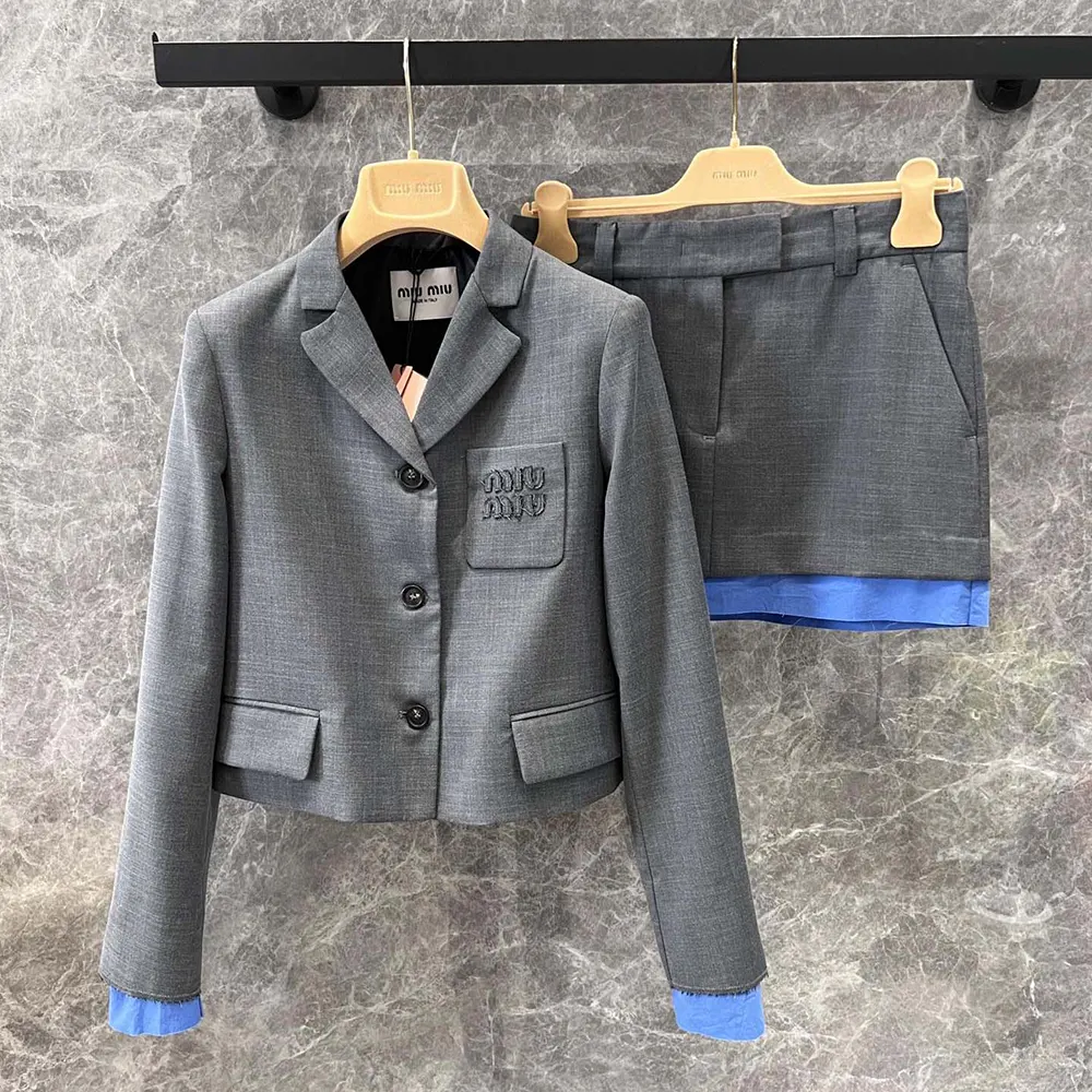 Close-up on single-breasted closure and gabardine texture of Miu Miu jacket
