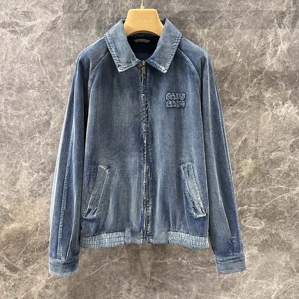 Close-up on zip and metal logo detail of the Miu Miu corduroy jacket