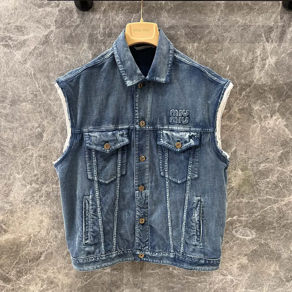 Close-up of button and corduroy texture on Miu Miu vest