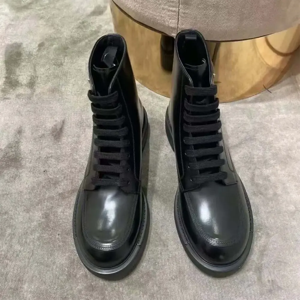 Close-up of brushed leather and polished metal eyelets on Prada boots