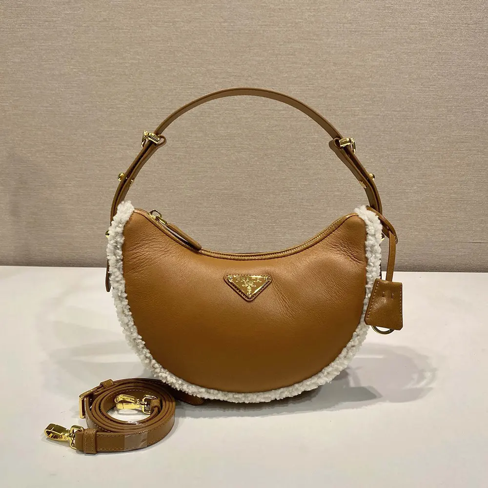 Close-up of plush shearling texture and gold hardware on Prada shoulder bag