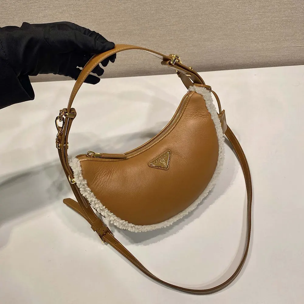 Side angle showing silhouette and adjustable strap of Prada Women Arqué bag