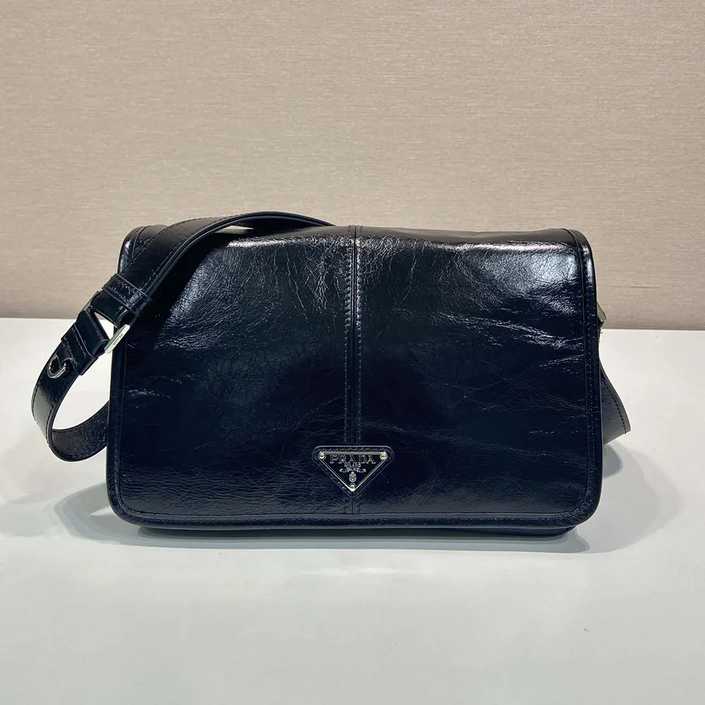 Close-up of Prada logo and black calf leather texture