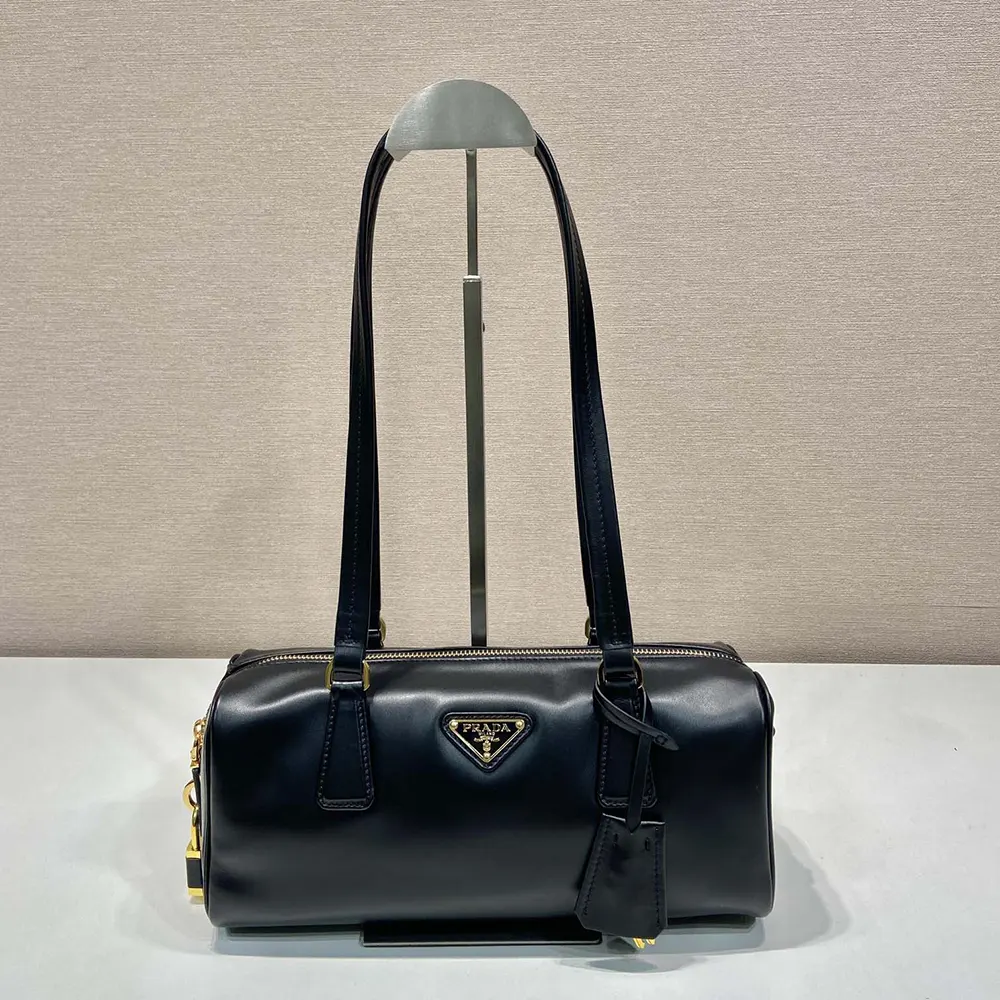 Close-up of silver padlock detail on Prada Women Medium Leather Top-handle Bag