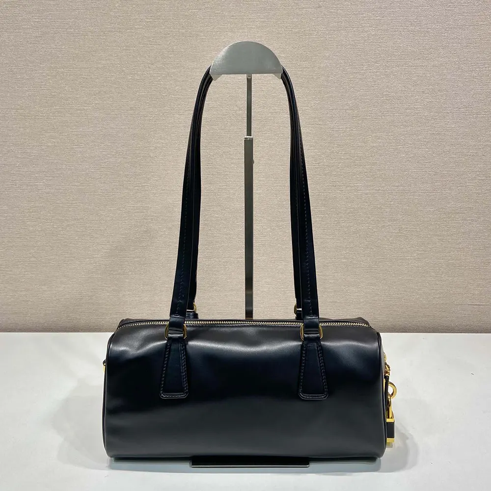 Side angle showing structured silhouette of Prada Women Medium Leather Top-handle Bag