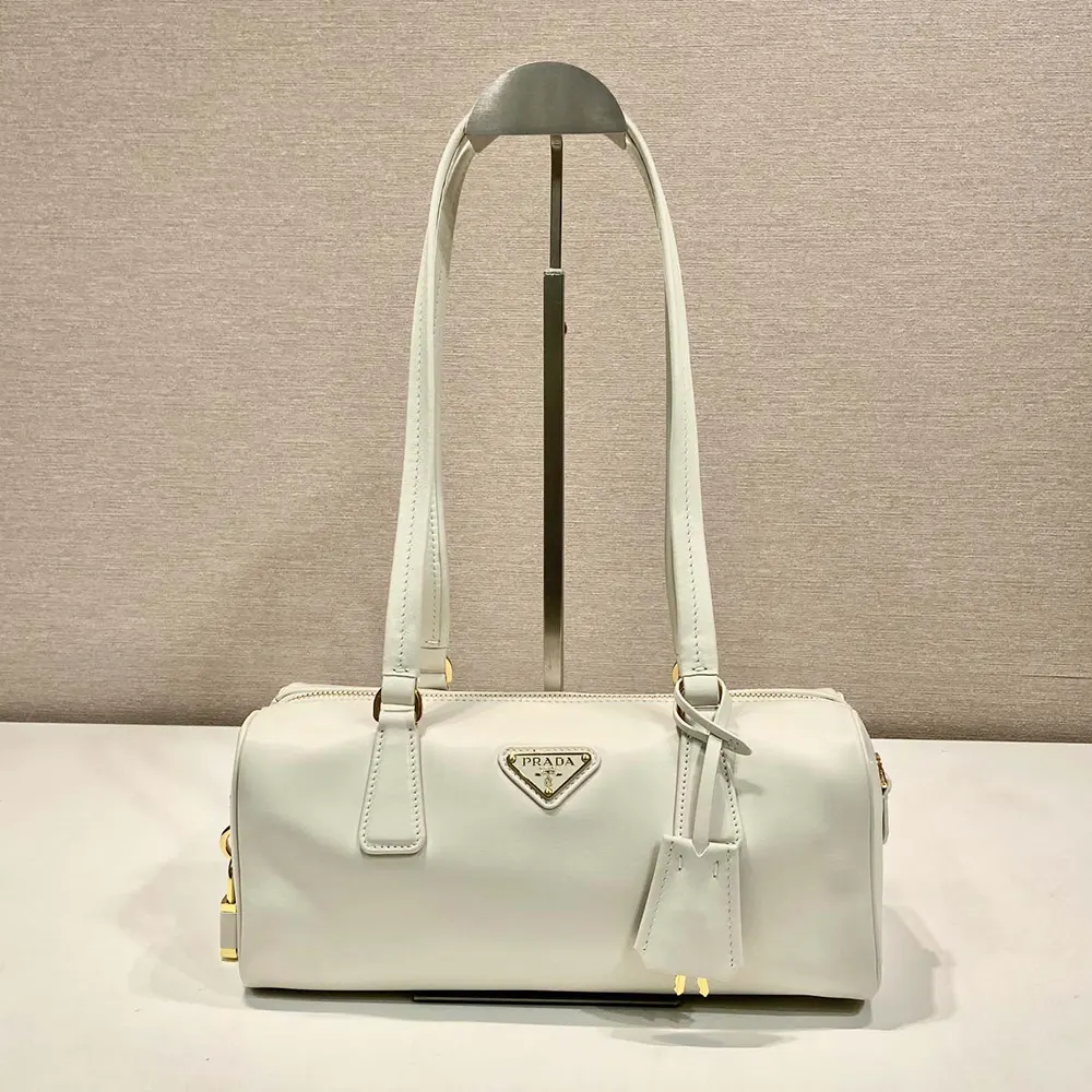 Close-up of silver padlock on Prada Women Medium Leather Top-handle Bag