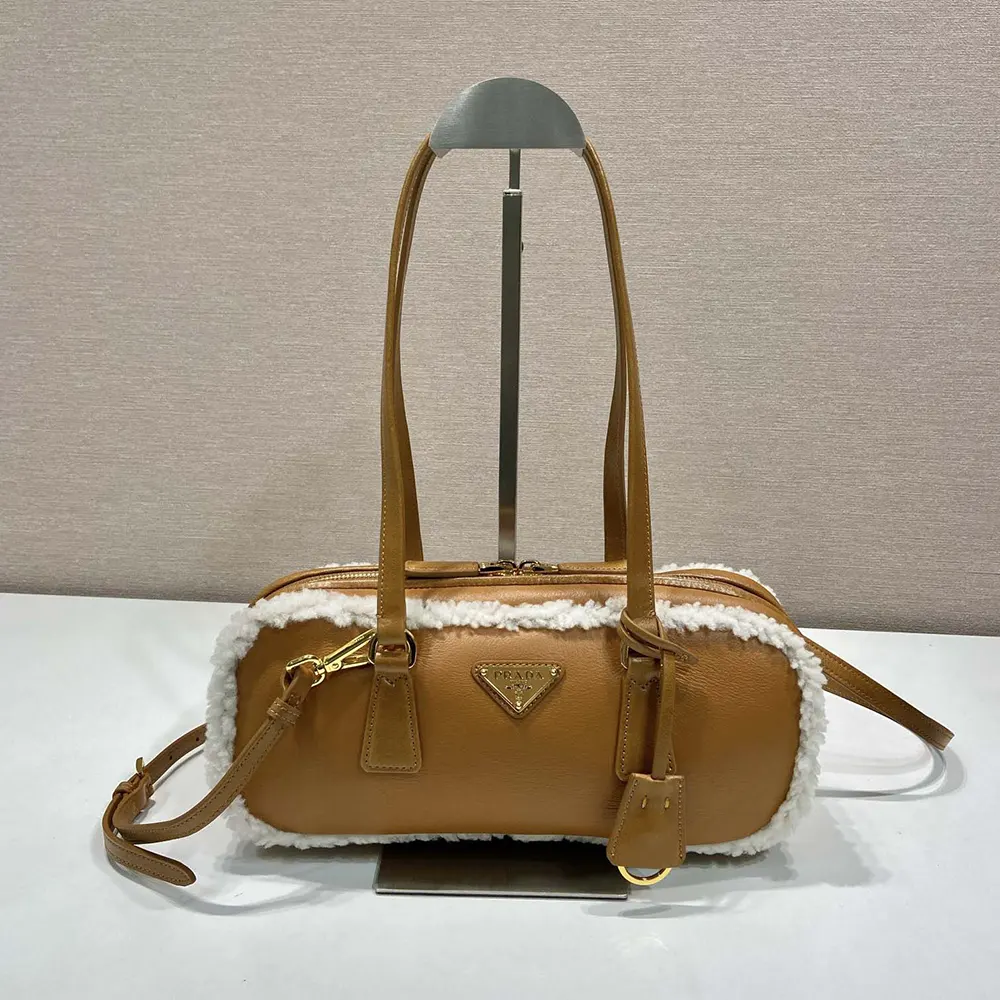 Close-up of shearling texture and gold hardware on Prada bag
