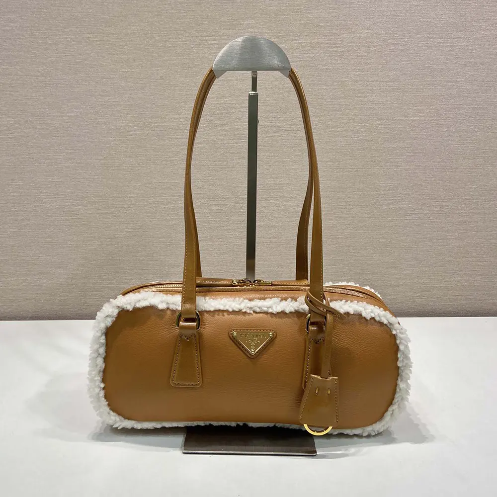 Side profile showing two handles and brown leather trim on Prada bag