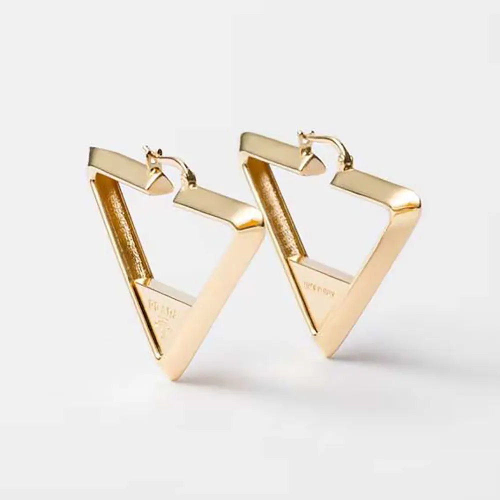 Close-up front view of Prada Women Metal Earrings in gold tone