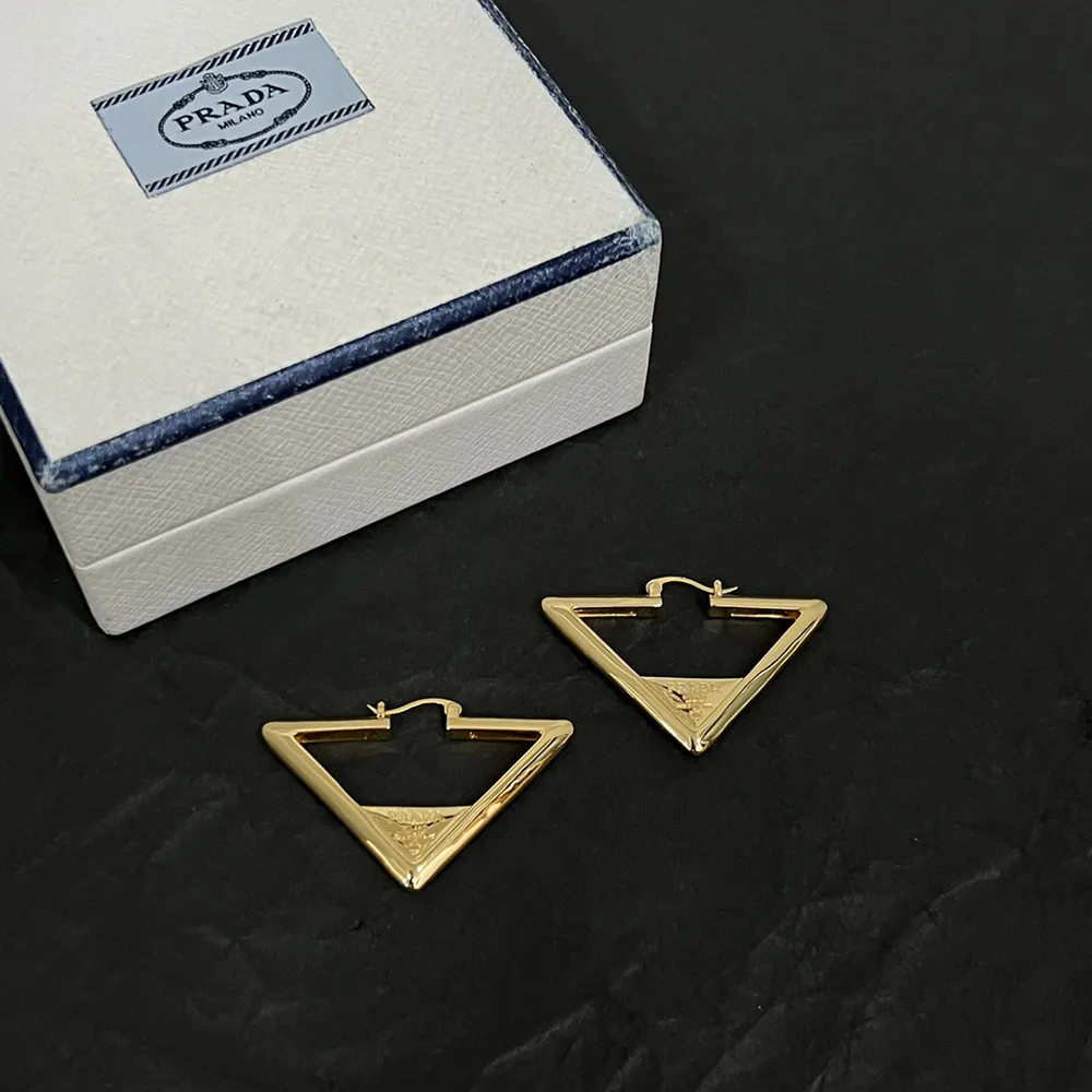 Detail of engraved Prada logo on Prada Women Metal Earrings