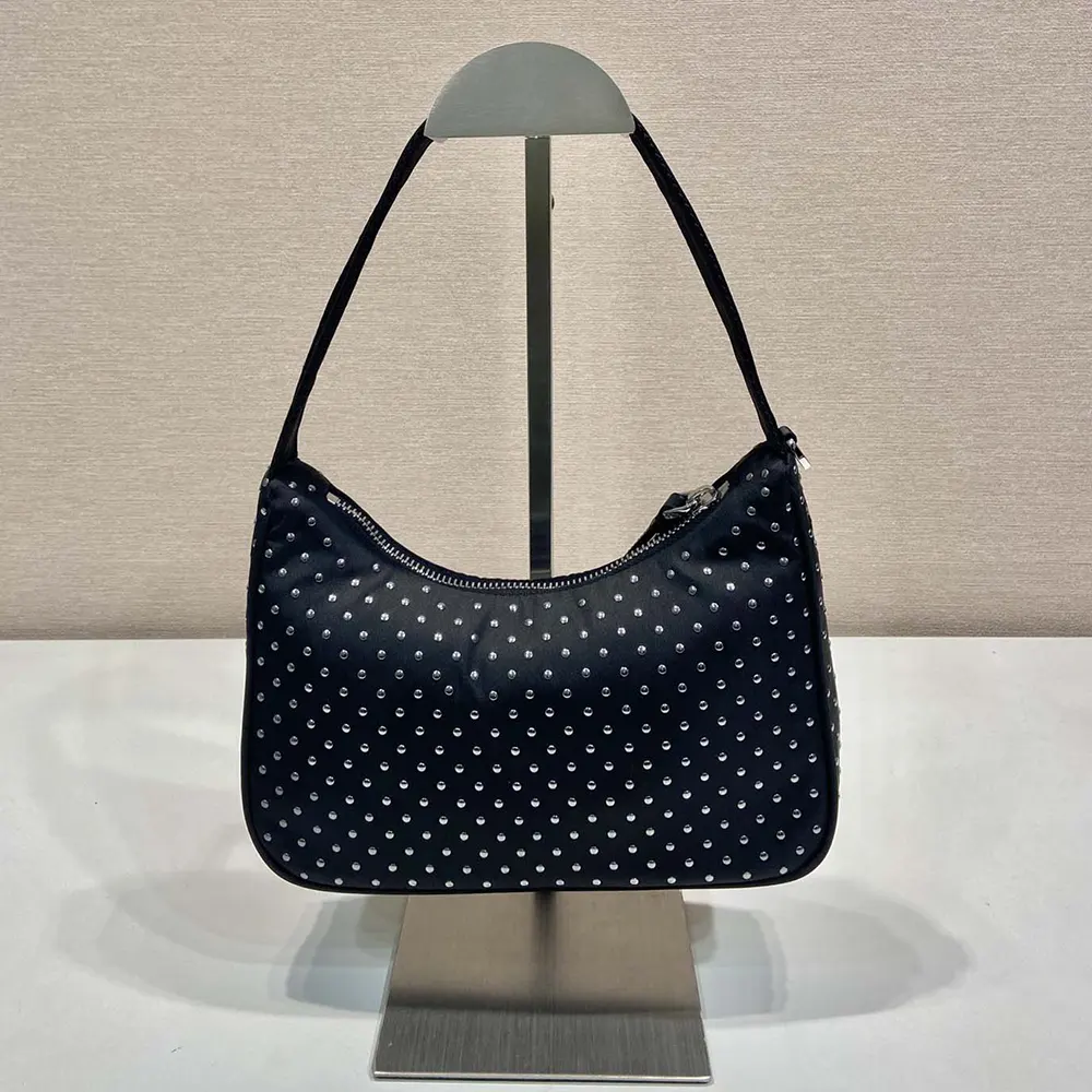 Close-up of pyramid studs on Prada Women Re-Edition Re-Nylon Mini Bag