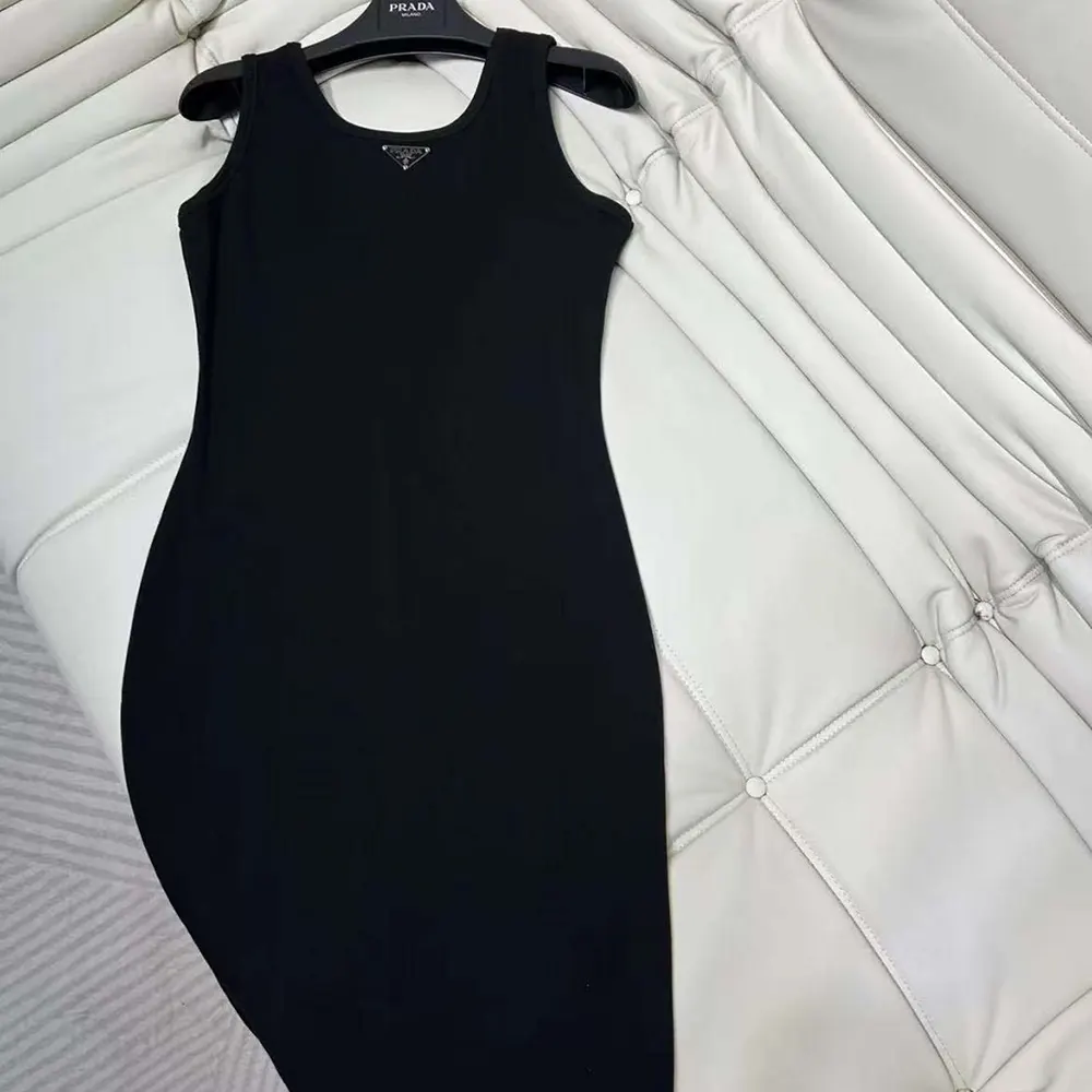 Side angle of Prada Women Ribbed knit jersey Midi-dress-Black highlighting length and fit