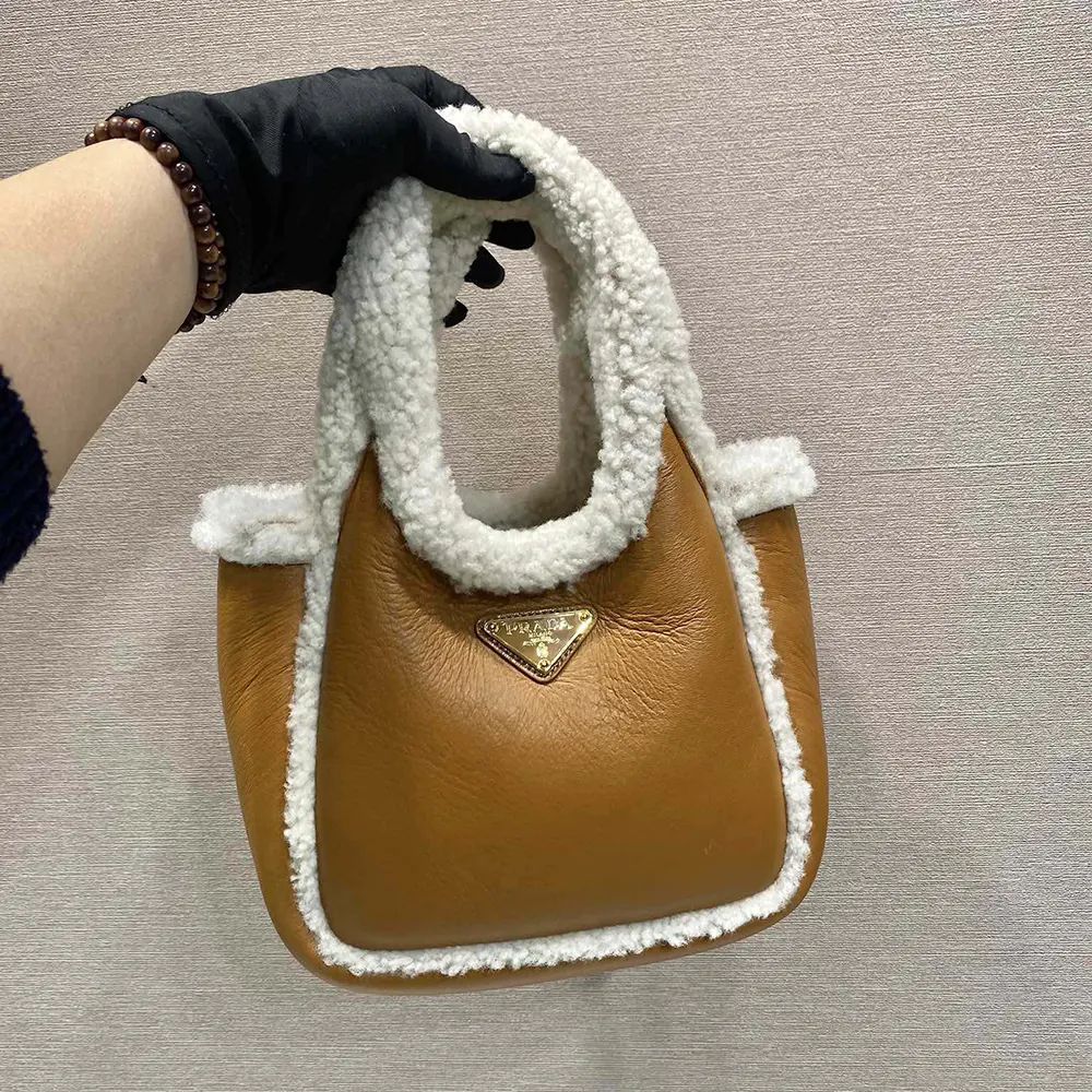 Close-up of gold hardware and closure on Prada Women Shearling Mini Handbag