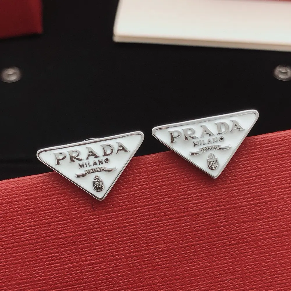 Side angle of white Prada Women Symbole Earrings highlighting closure