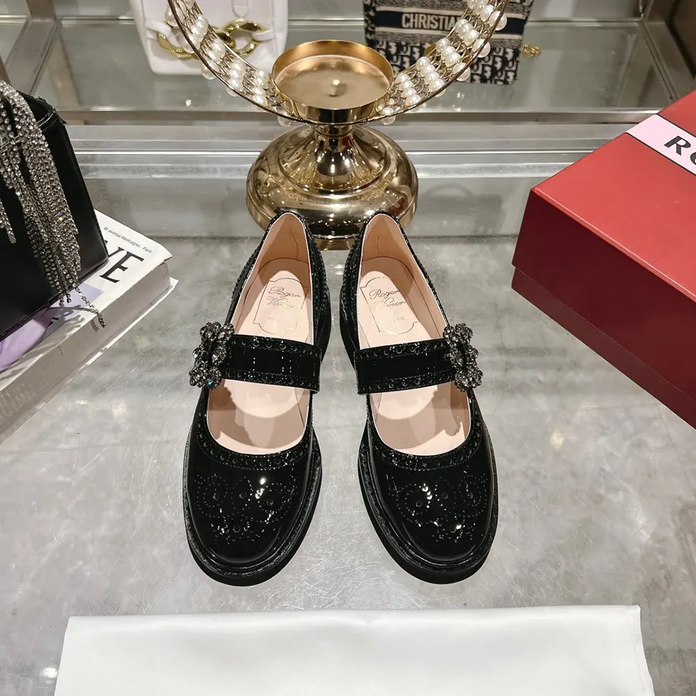 Close-up on signature oversized metal buckle of Roger Vivier Women Viv’ Rangers Mary Janes