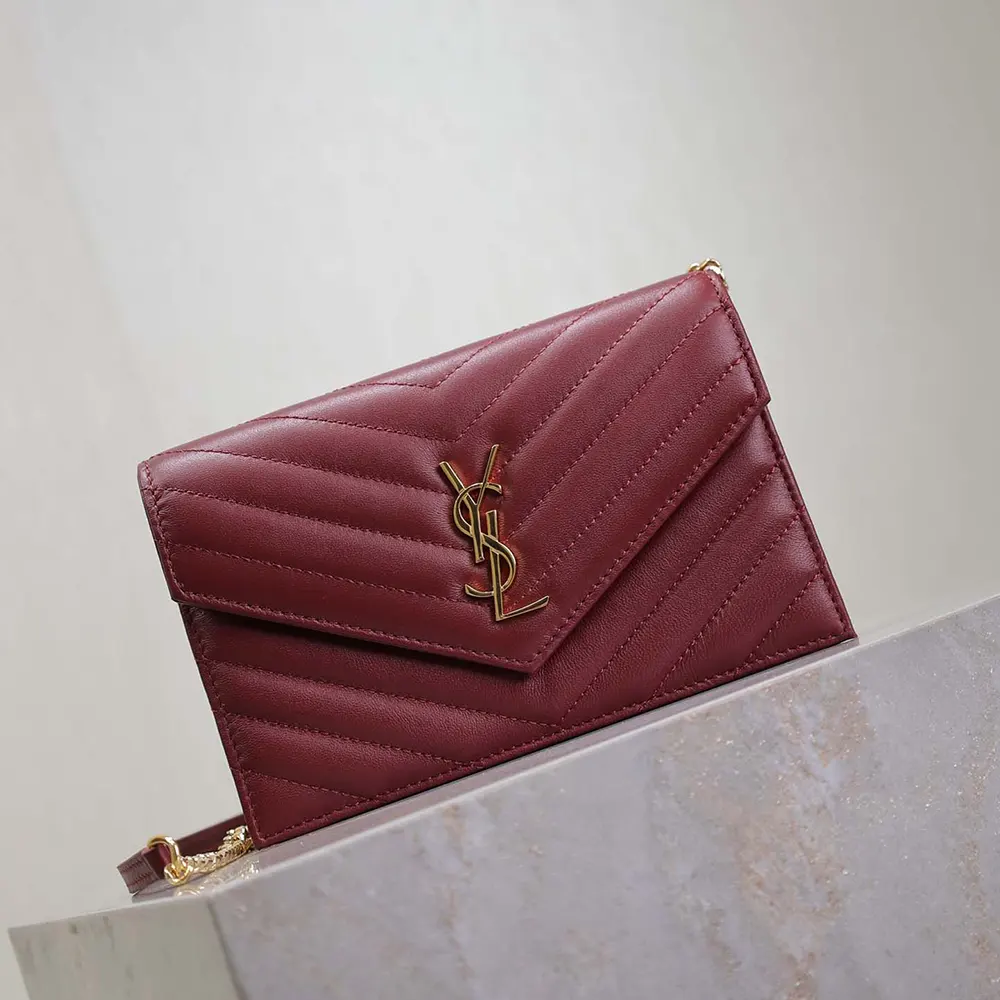 Side angle showing slim profile of Saint Laurent YSL envelope chain wallet