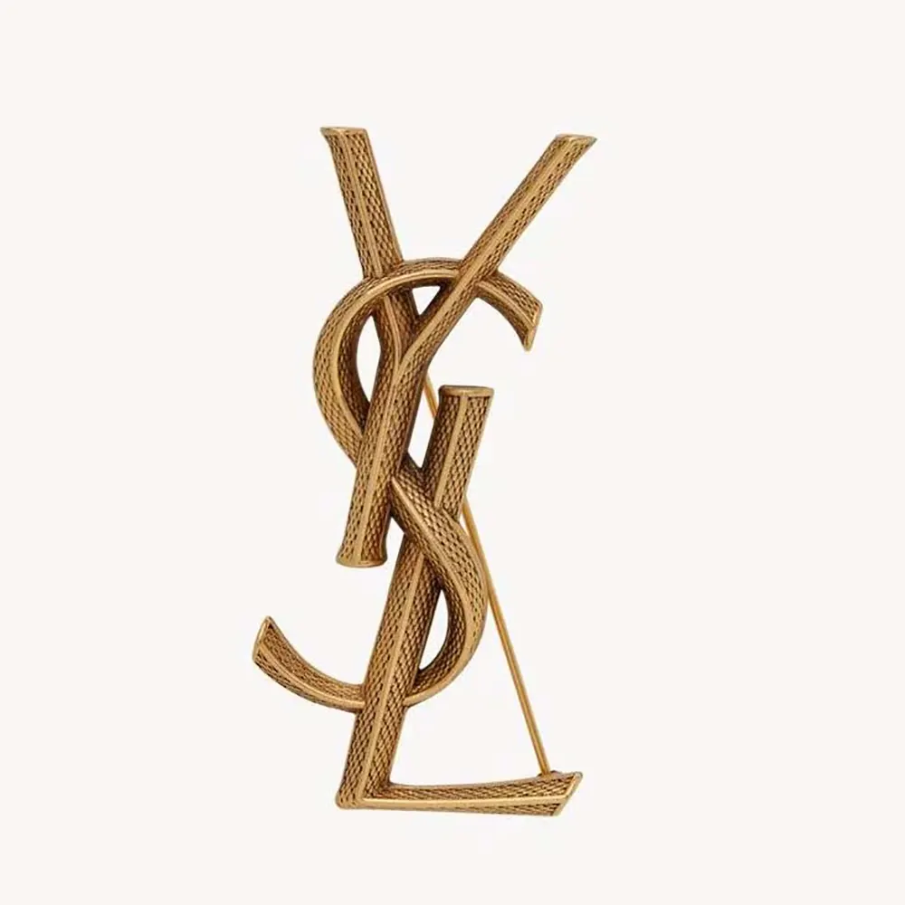 Close-up of Saint Laurent YSL Women Cassandre Snake Brooch in metal gold-tone