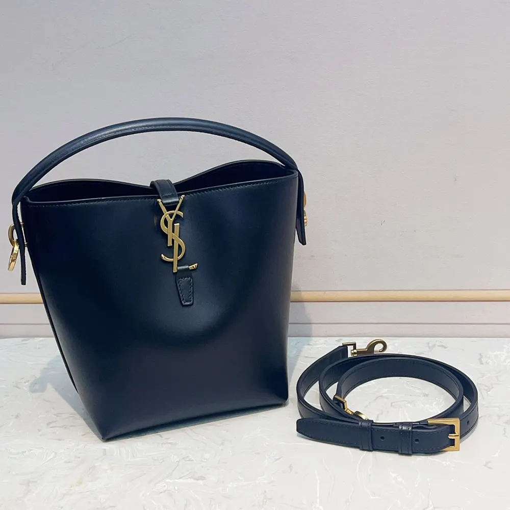 Side view detailing shiny leather and magnetic flap closure