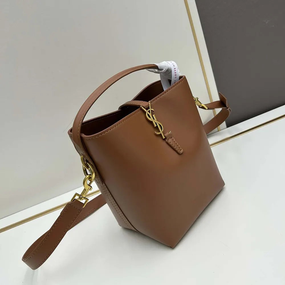 Side angle showing shoulder strap and magnetic flap closure on Saint Laurent bag
