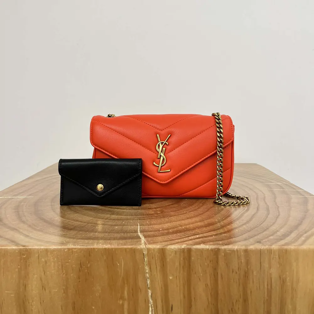 Close-up of gold YSL logo hardware on Loulou Mini lambskin shoulder bag