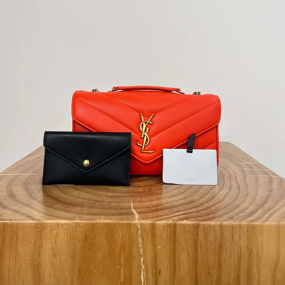 Close-up on gold YSL logo hardware of Loulou Small shoulder bag