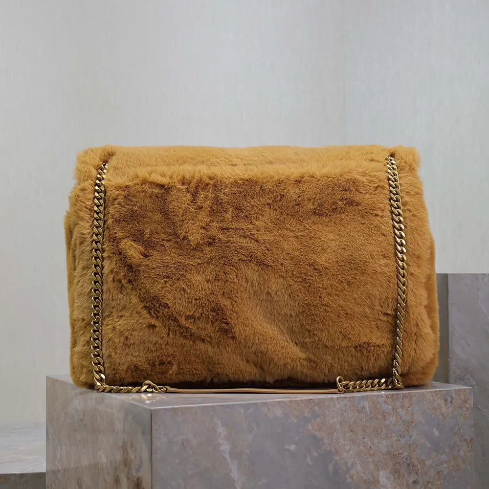 Side profile showing feather detail and spacious shape of Saint Laurent bag