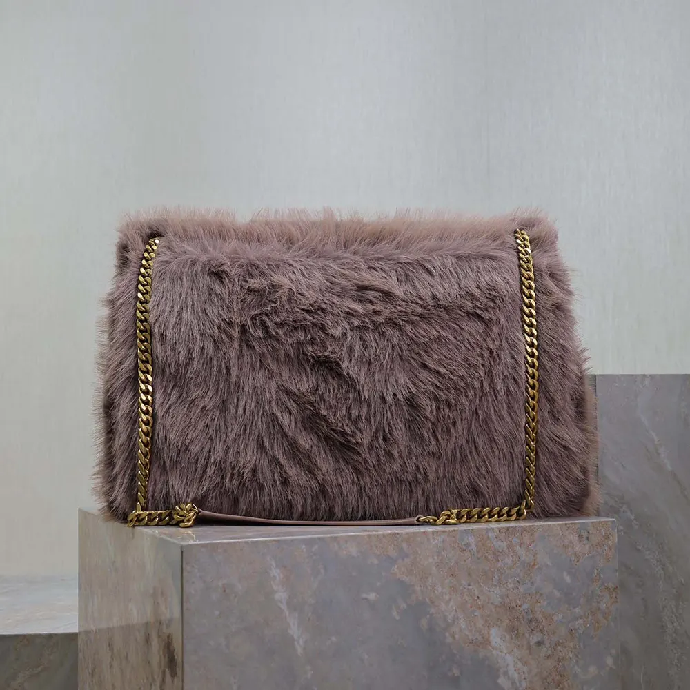 Side profile showing flap closure and feather texture of Saint Laurent Niki