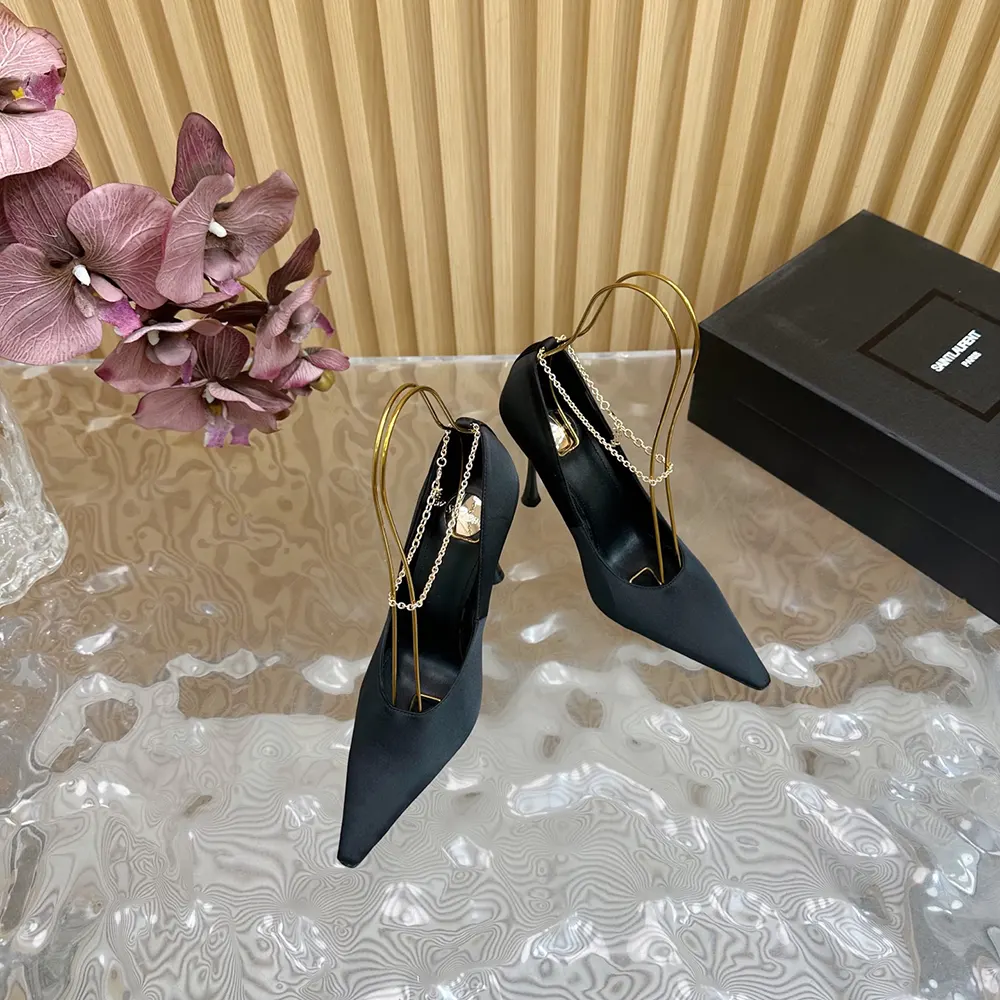 Close-up of YSL logo hardware on Saint Laurent Regine Pumps heel