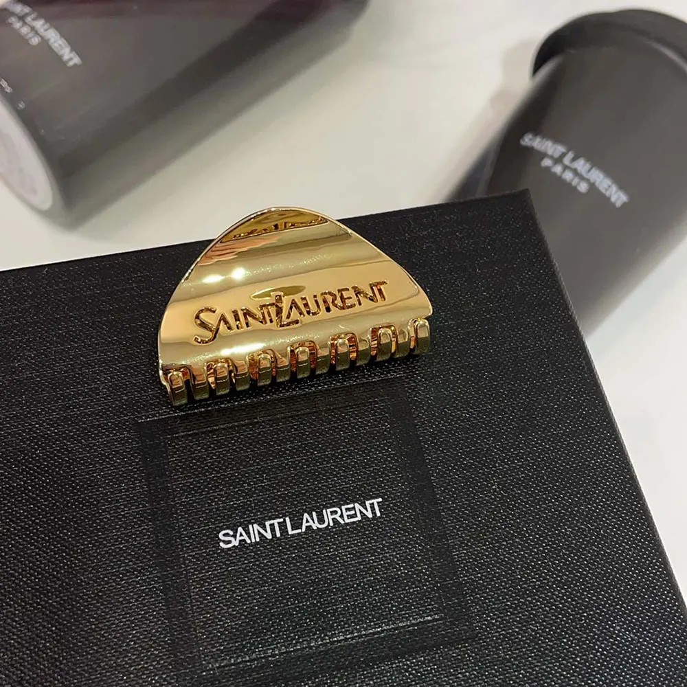 Side view showcasing gold finish and YSL logo of Saint Laurent claw clip