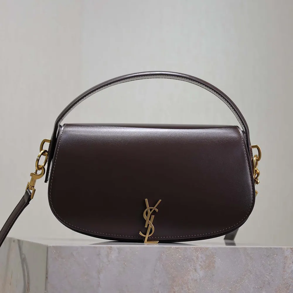 Close-up of gold YSL logo and closure on Voltaire shoulder bag
