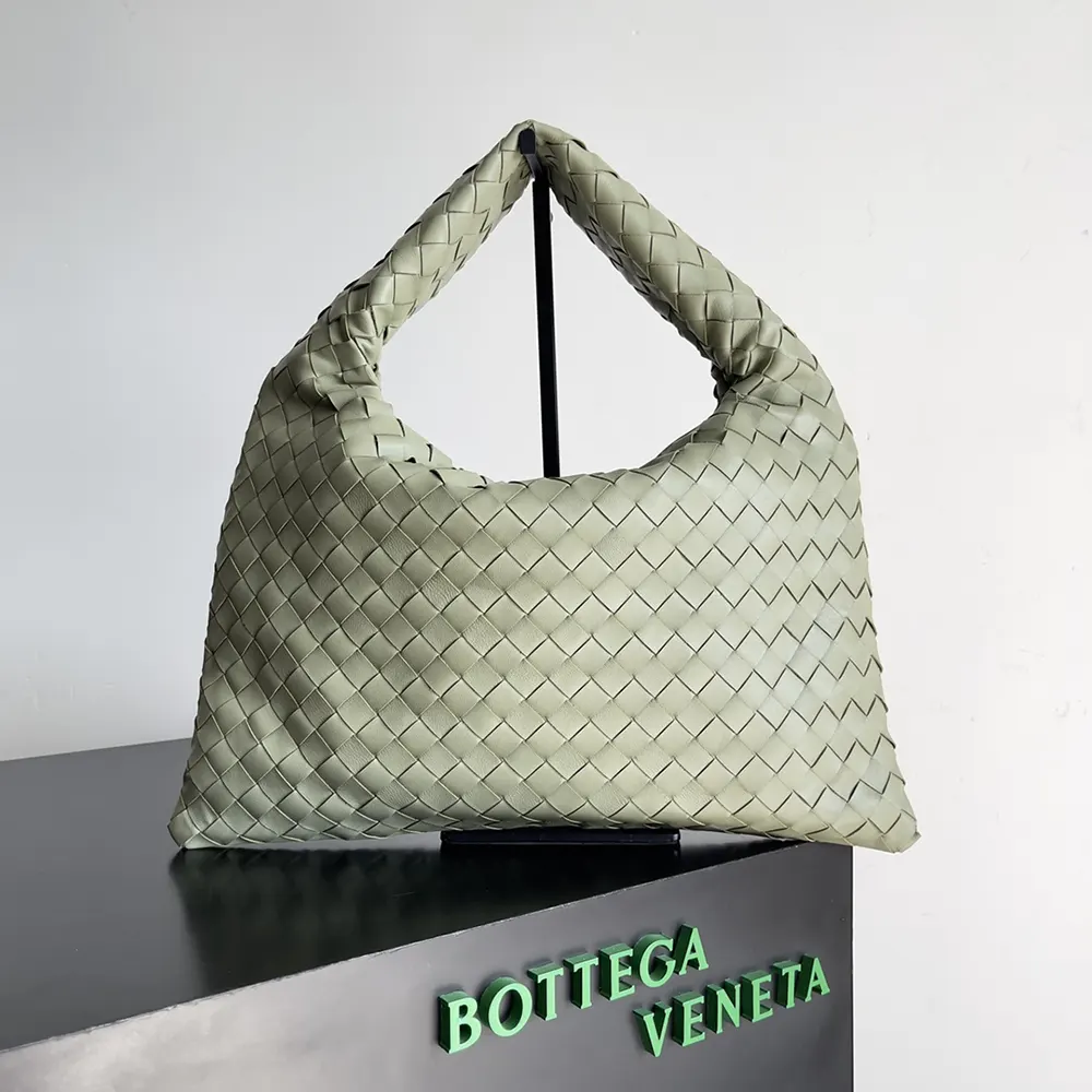 Close-up of gold hardware and magnetic closure on olive shoulder bag