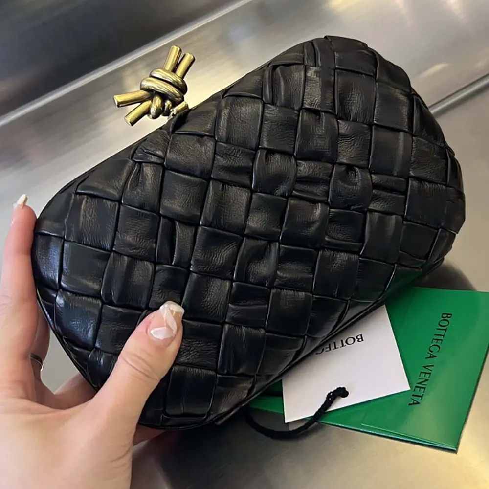 Side profile showing compact silhouette of Bottega Veneta Women Knot Minaudière Clutch