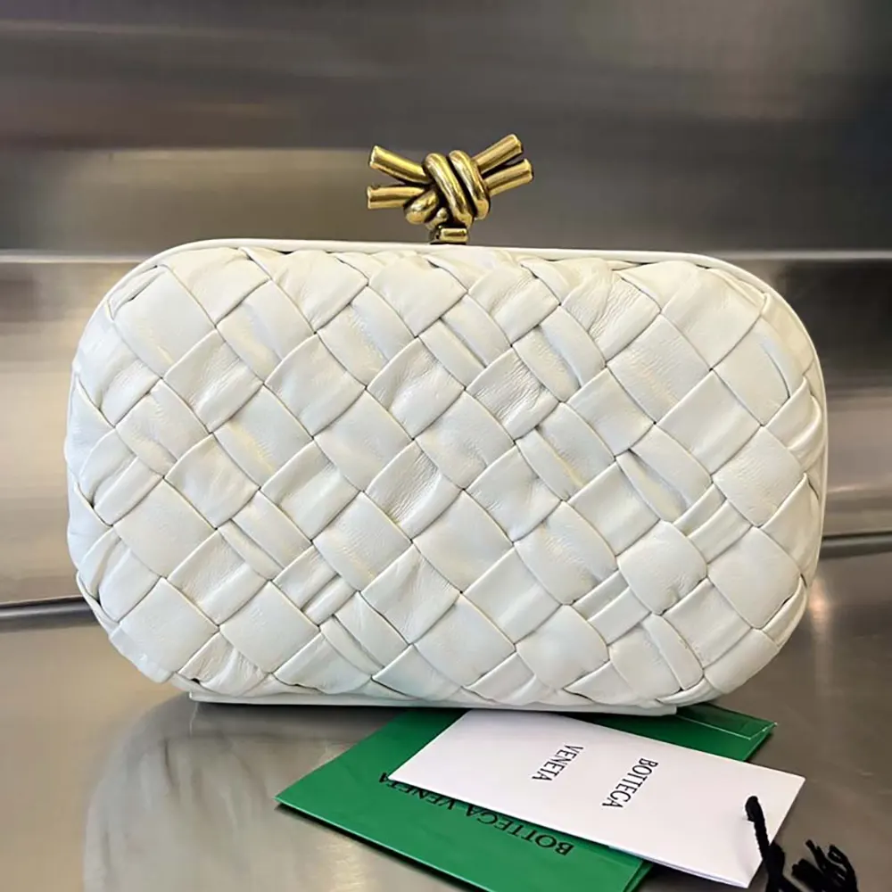 Close-up of signature knot closure on Bottega Veneta white clutch