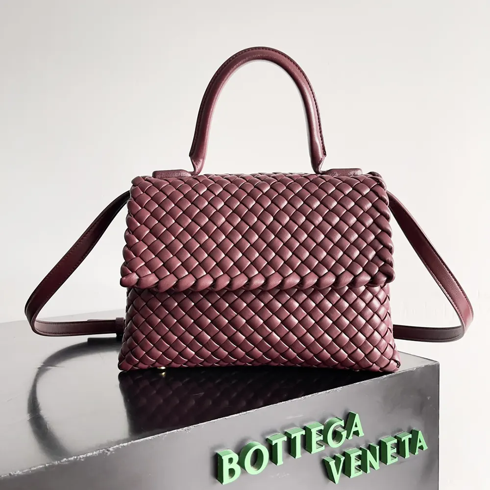 Close-up of padded intrecciato leather and gold hardware detail