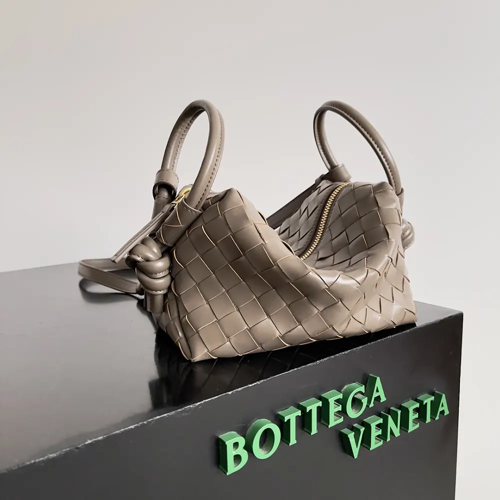 Side angle showing structured silhouette of Bottega Veneta chocolate top handle bag