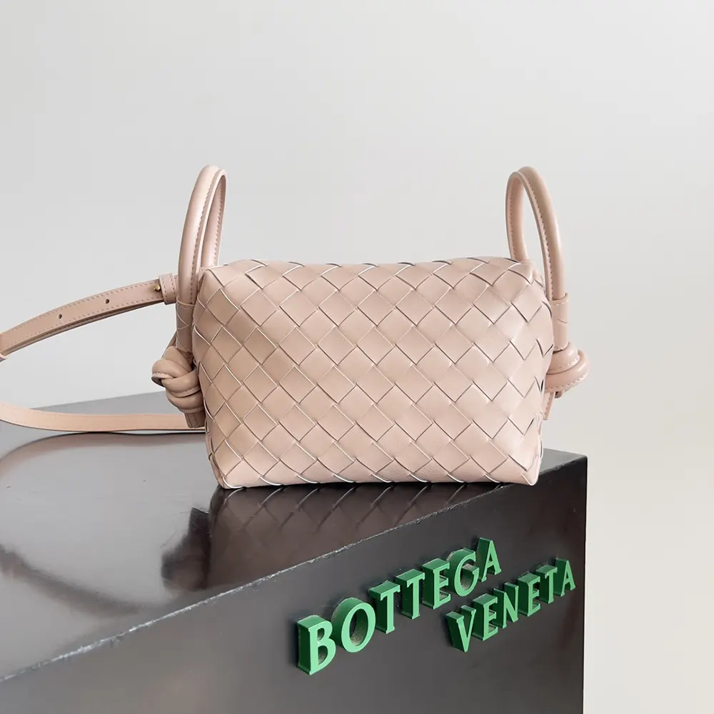 Close-up of pink Intrecciato leather texture and gold hardware detail