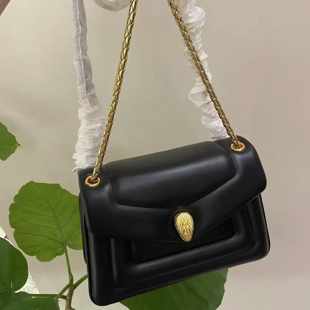Close-up of gold-tone Serpenti snake hardware on Bvlgari Women Serpenti Reverse Shoulder Bag-Black
