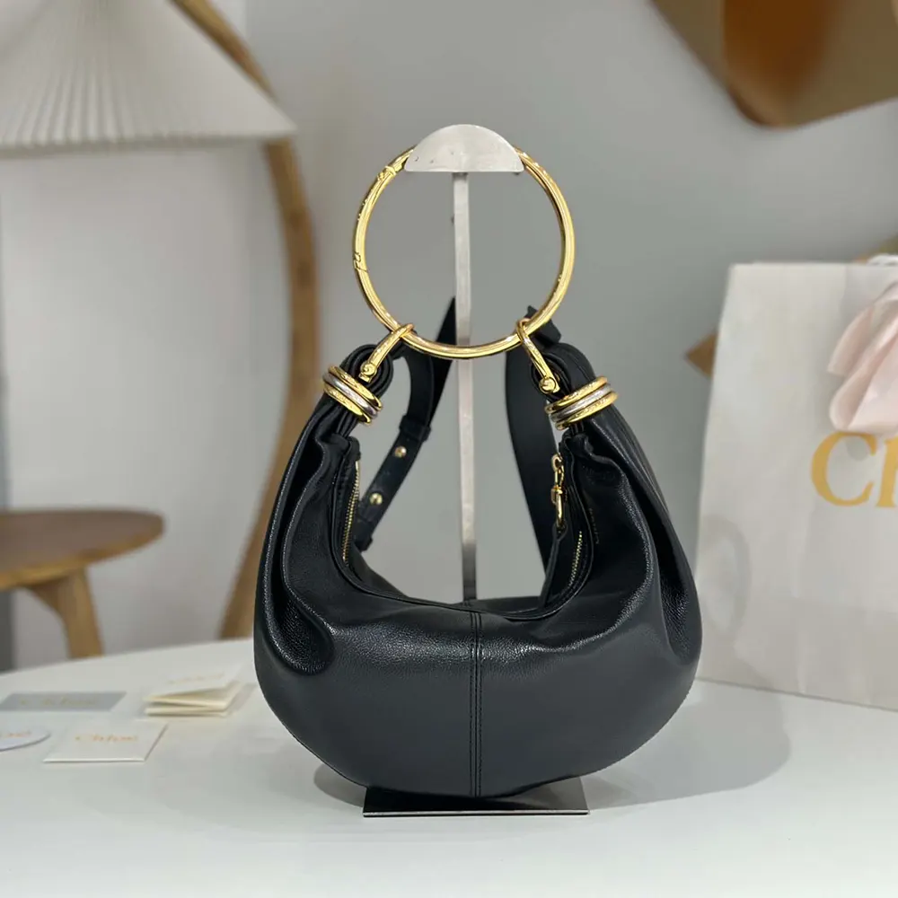 Close-up of gold-tone bracelet handle on Chloe Small Bracelet Hobo Bag