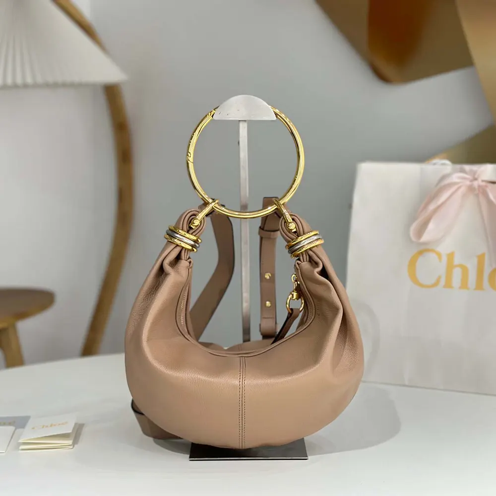 Close-up of signature gold bracelet handle on Chloe Women Small Bracelet Hobo Bag