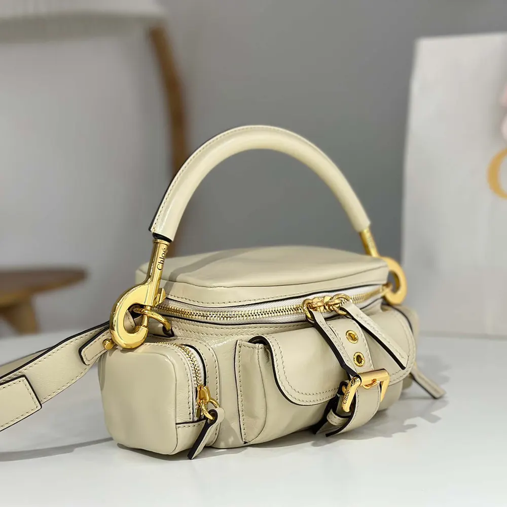 Side angle showing adjustable strap on Chloe Women Small Camera Bag in Beige