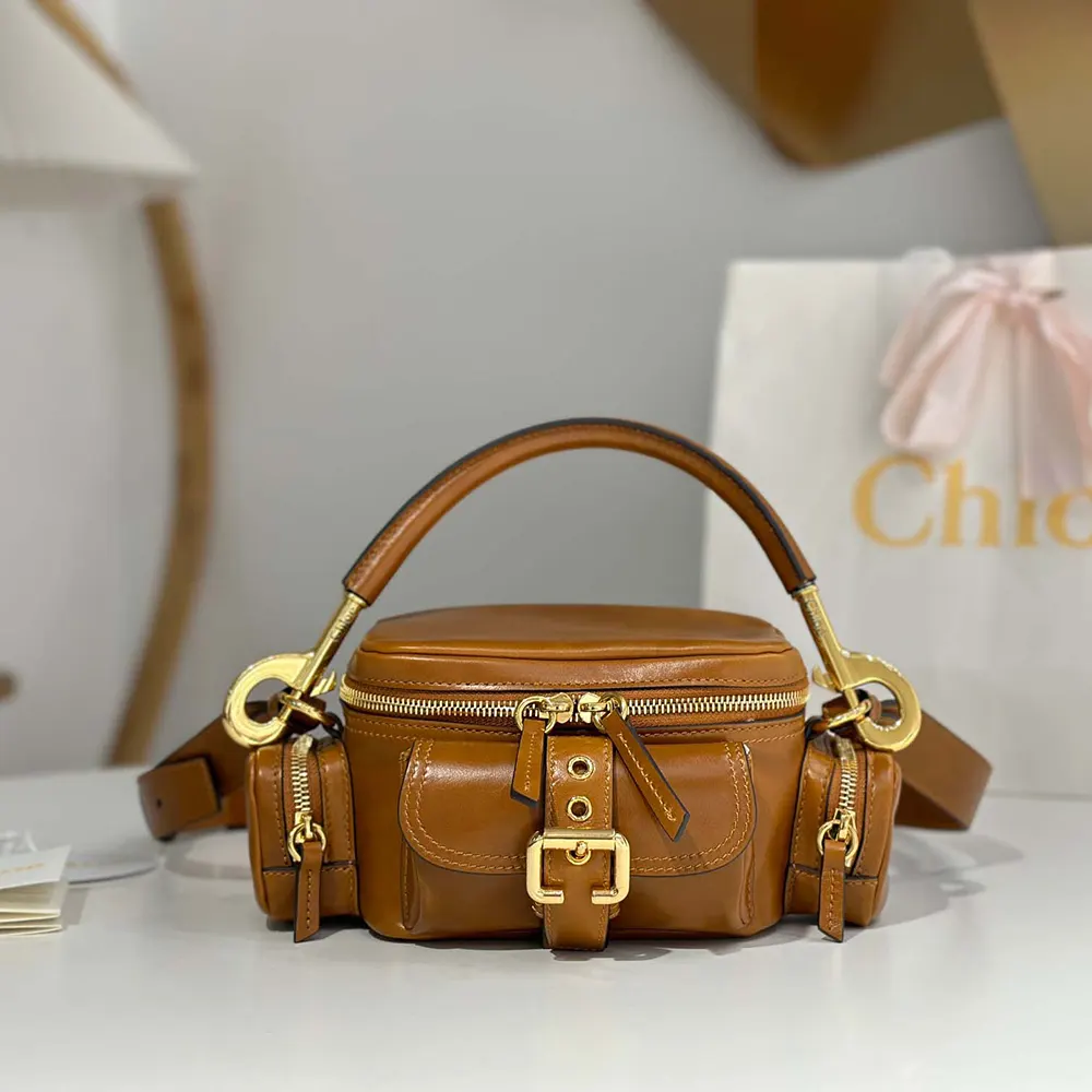Close-up of gold hardware and signature charm on Chloe Women Small Camera Bag