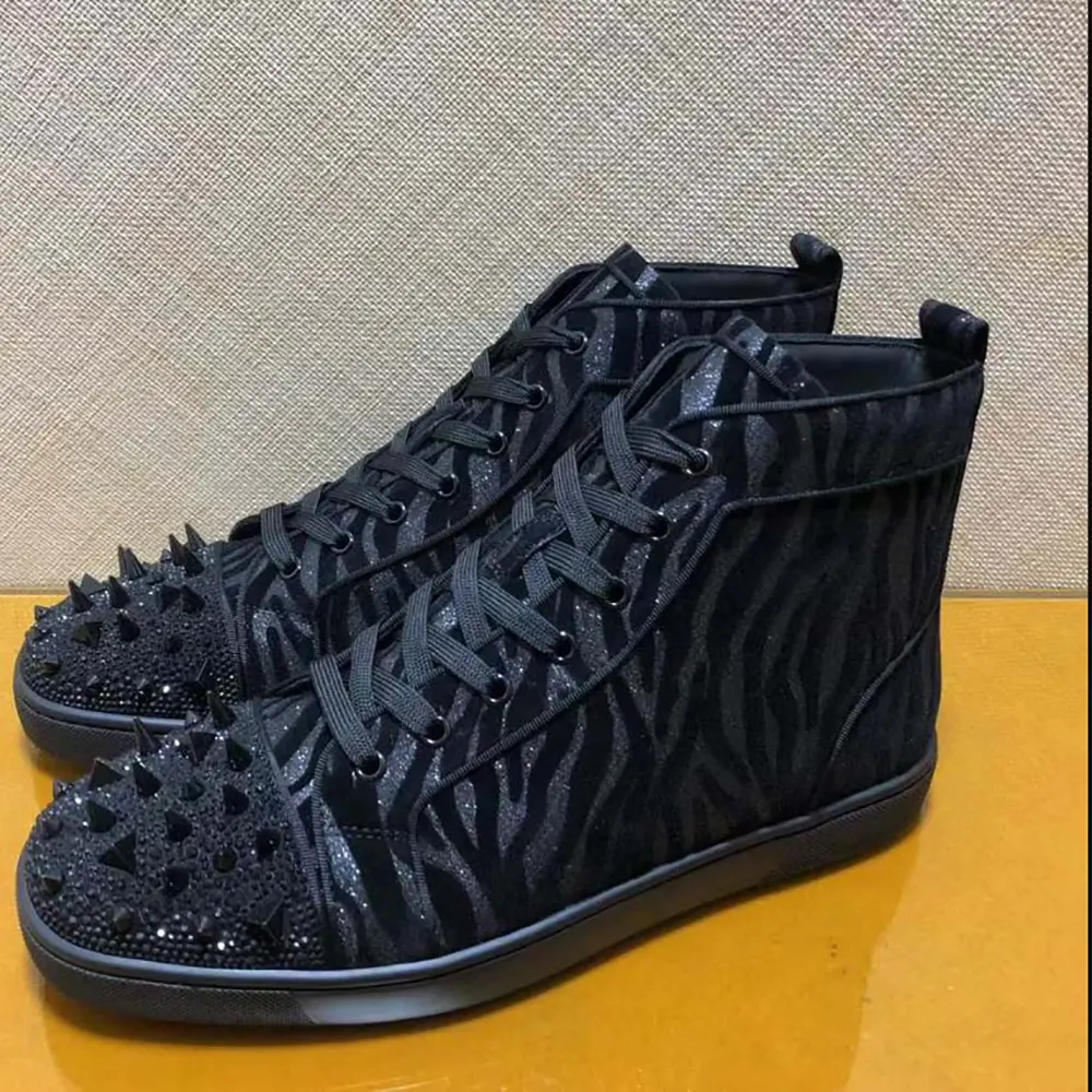 Top angle showing black velvet texture and lace-up detailing on Christian Louboutin sneakers