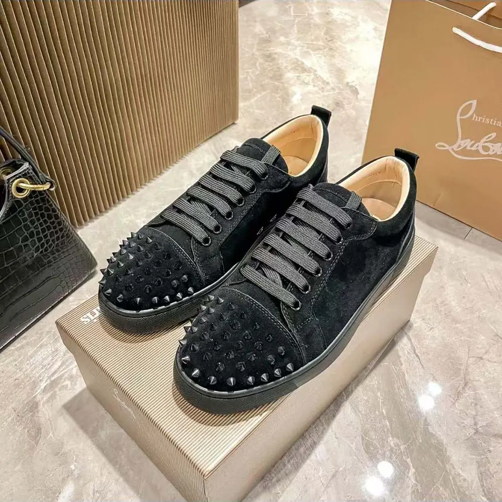 Close-up of black suede and signature spikes on Louis Junior Spikes Sneakers