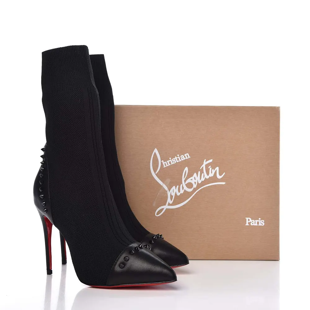 Close-up of black nappa leather and knit detail on Christian Louboutin ankle boots