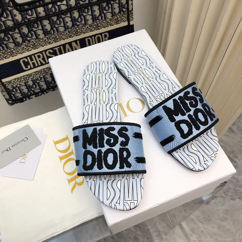 Close-up detail of pale blue Miss Dior embroidery on slide