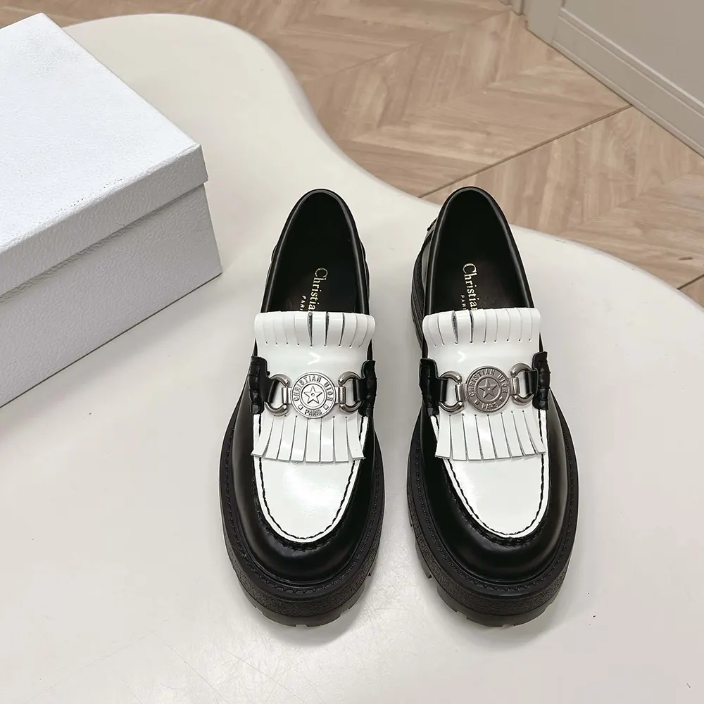 Close-up on Dior emblem hardware of Women Emblem Loafer in black and white